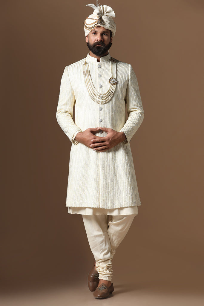 Distinguished by exquisite tonal threadwork, this Off-White Sherwani exudes elegance. Complete with kurta and pajama set for a refined ensemble.