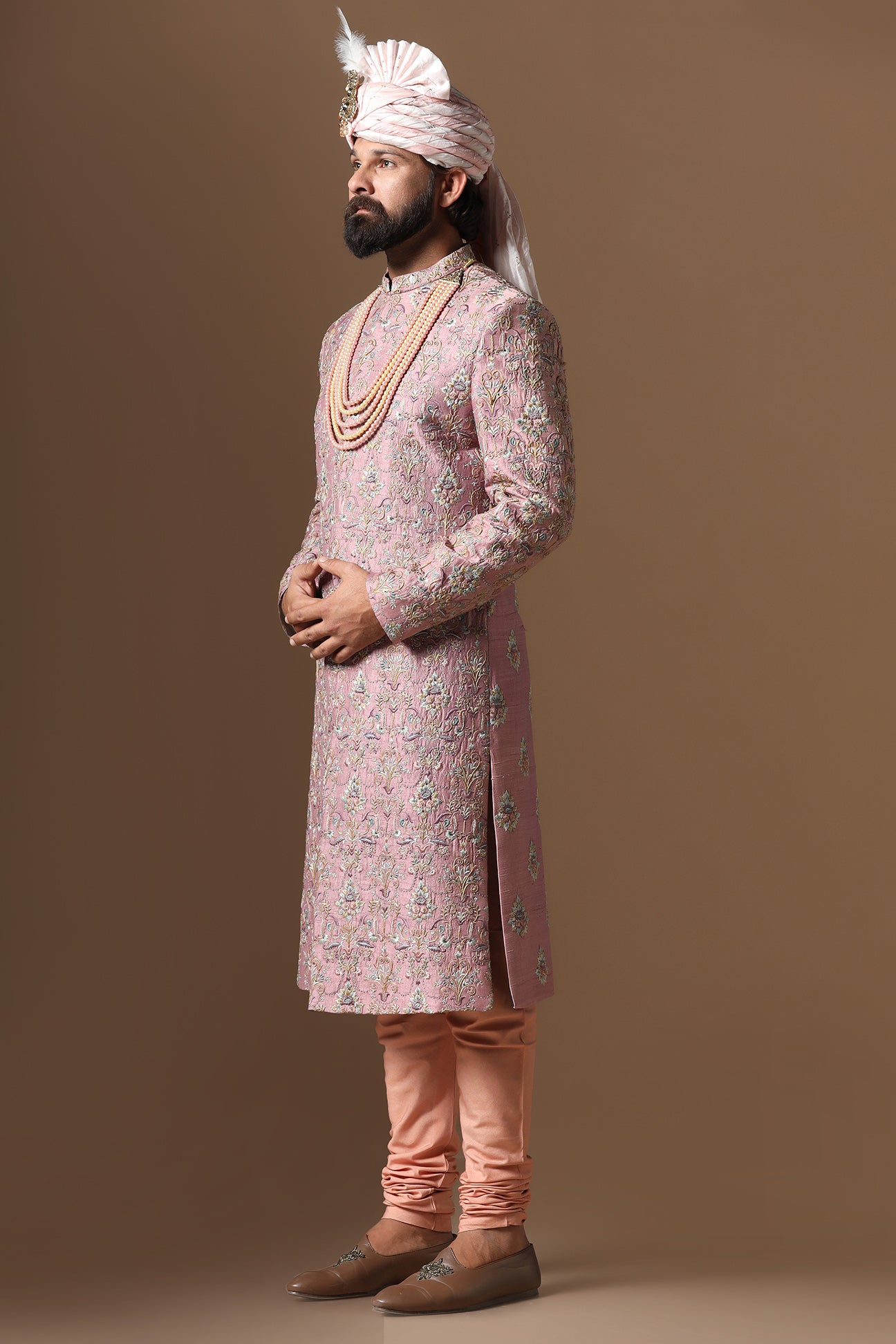 This pink embroidered Sherwani blends floral and geometric embroidery patterns. Shop Now!