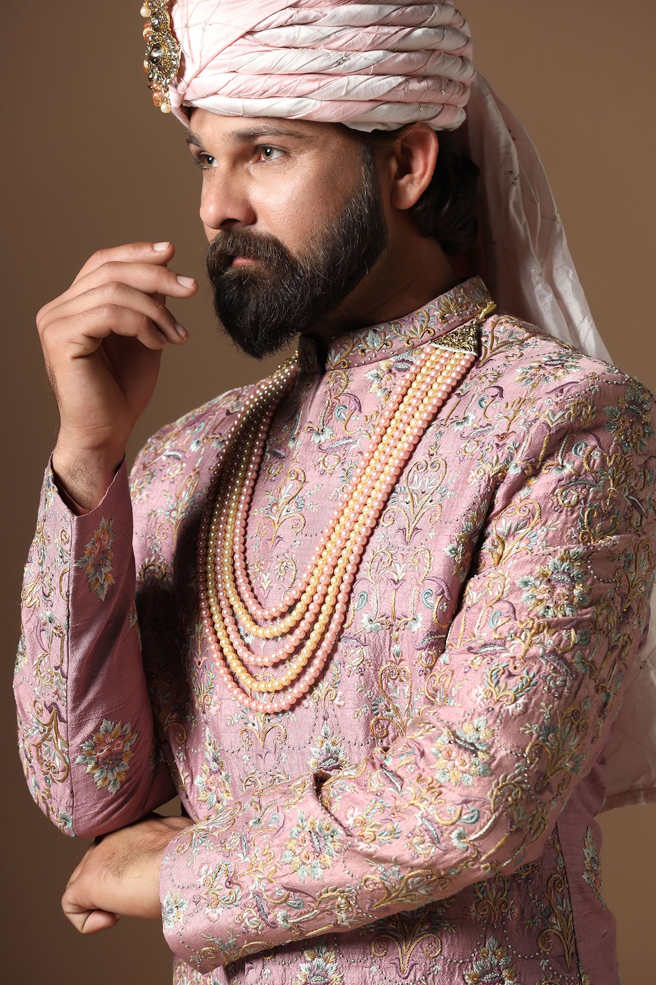 This pink embroidered Sherwani blends floral and geometric embroidery patterns. Shop Now!