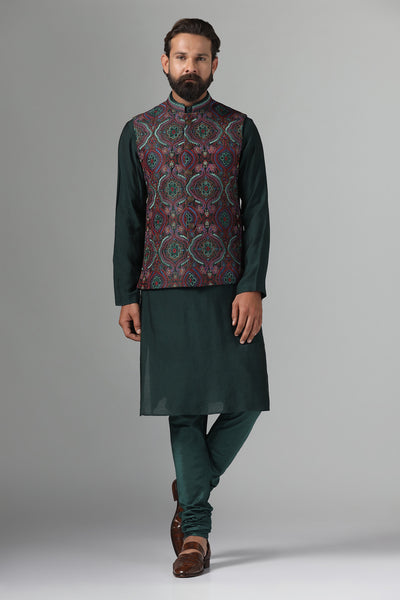 Stand out in style with our Nehru Jacket adorned in vibrant multi-colored embroidery. Paired with a green kurta and churidar trousers for a bold ensemble.