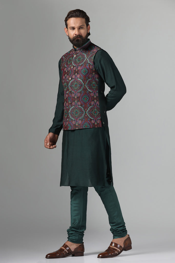 Stand out in style with our Nehru Jacket adorned in vibrant multi-colored embroidery. Paired with a green kurta and churidar trousers for a bold ensemble.