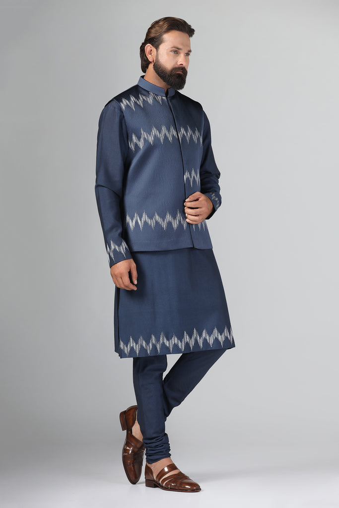 Step up your style with our navy blue Nehru Jacket crafted from textured fabric. Paired perfectly with a textured kurta and churidar trousers ensemble.