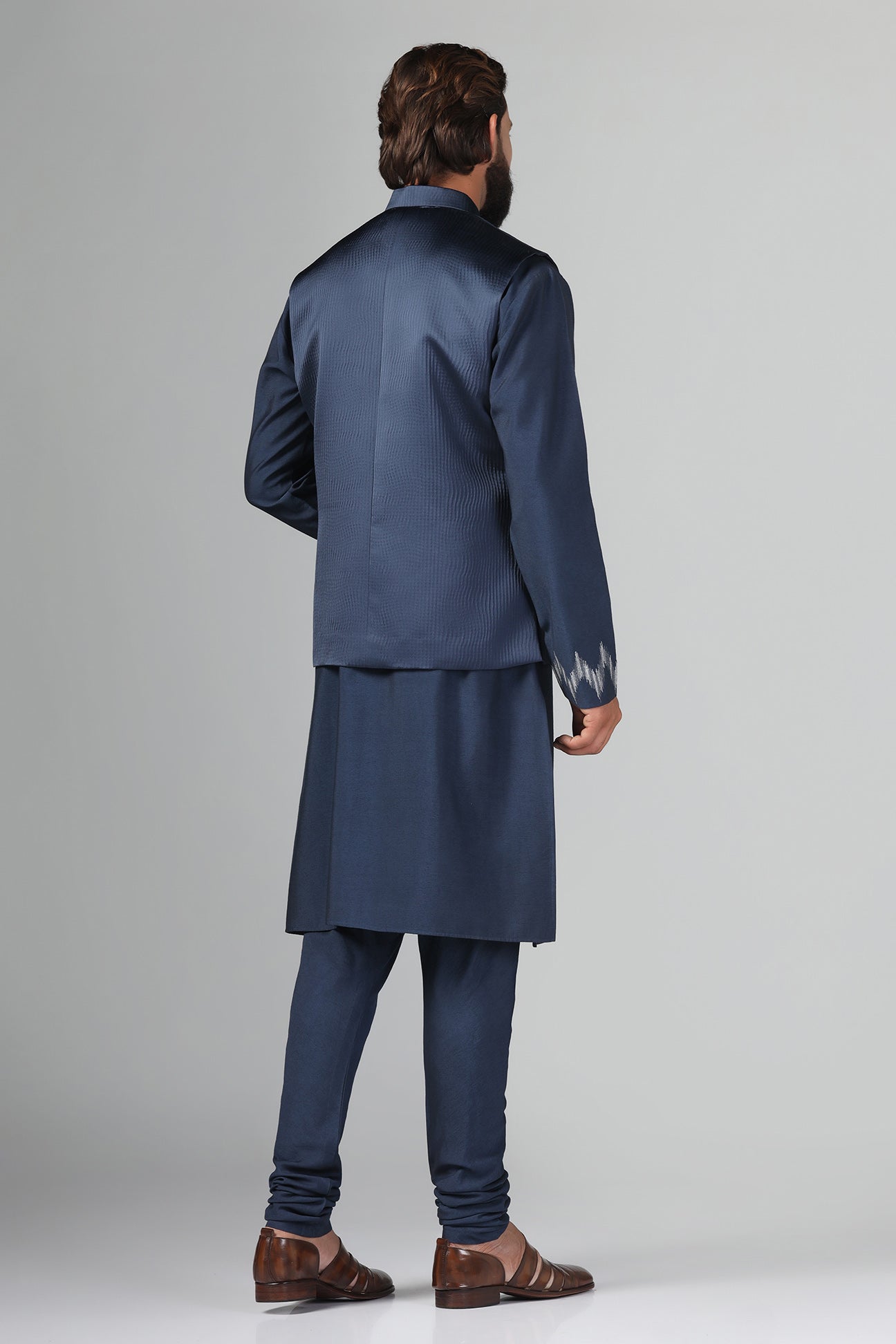 Step up your style with our navy blue Nehru Jacket crafted from textured fabric. Shop Now!