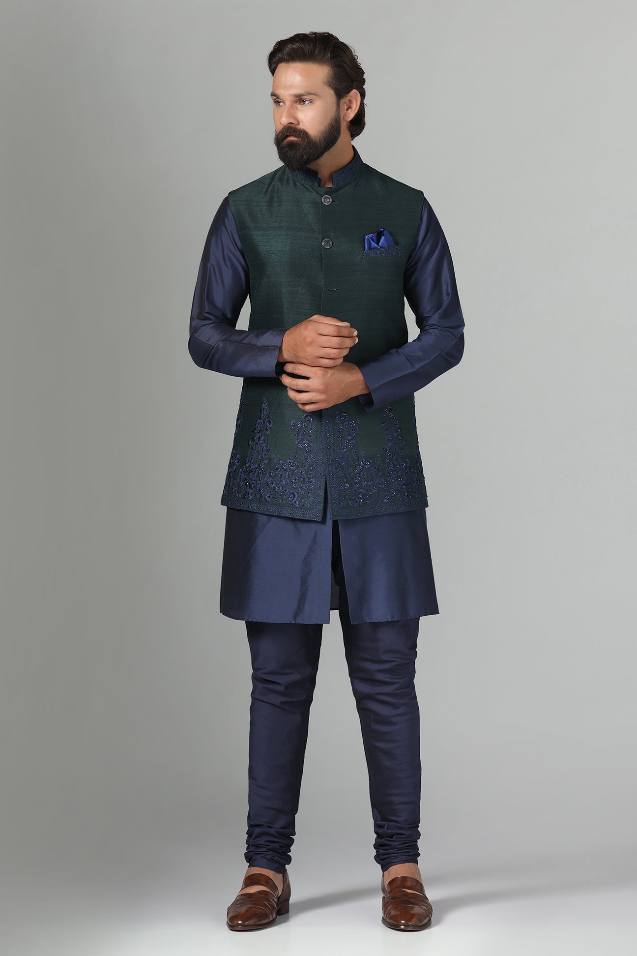 Crafted from luxurious raw silk, this green Nehru Jacket exudes sophistication. Shop Now!