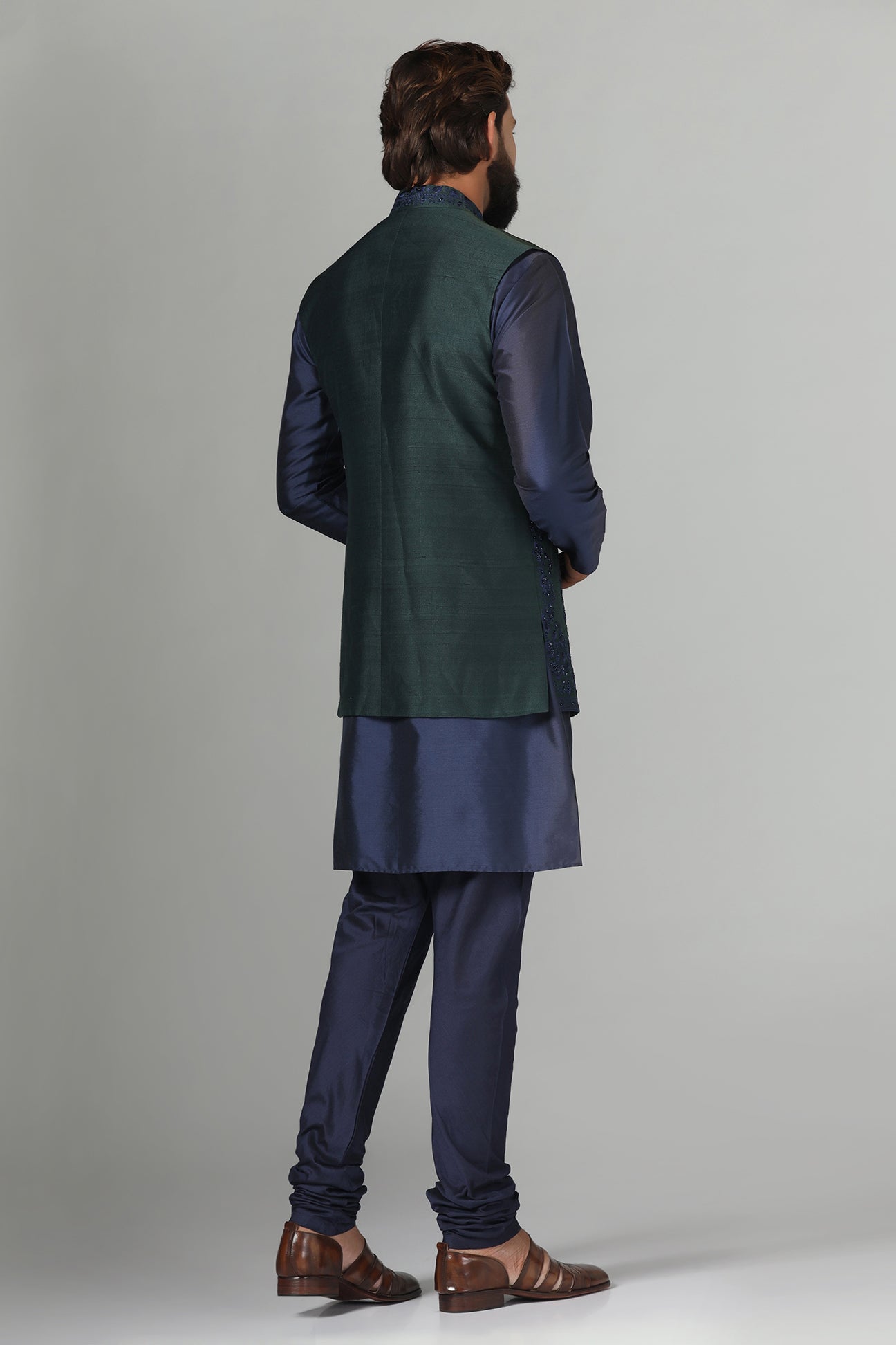 Crafted from luxurious raw silk, this green Nehru Jacket exudes sophistication. Shop Now!