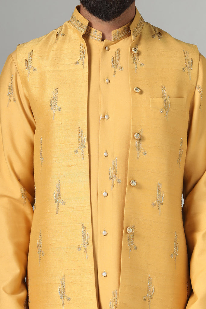 Elevate your style with our Raw-Silk Nehru jacket adorned with delicate embroidery. Complete with an embroidered kurta and pajama set for a refined ensemble.