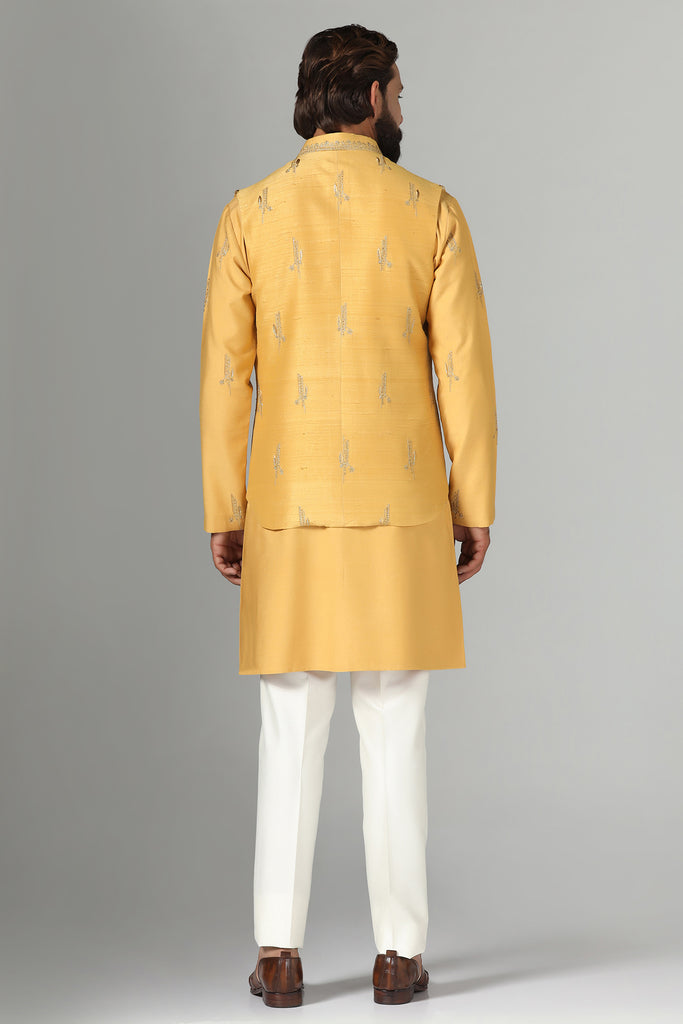 Elevate your style with our Raw-Silk Nehru jacket adorned with delicate embroidery. Complete with an embroidered kurta and pajama set for a refined ensemble.