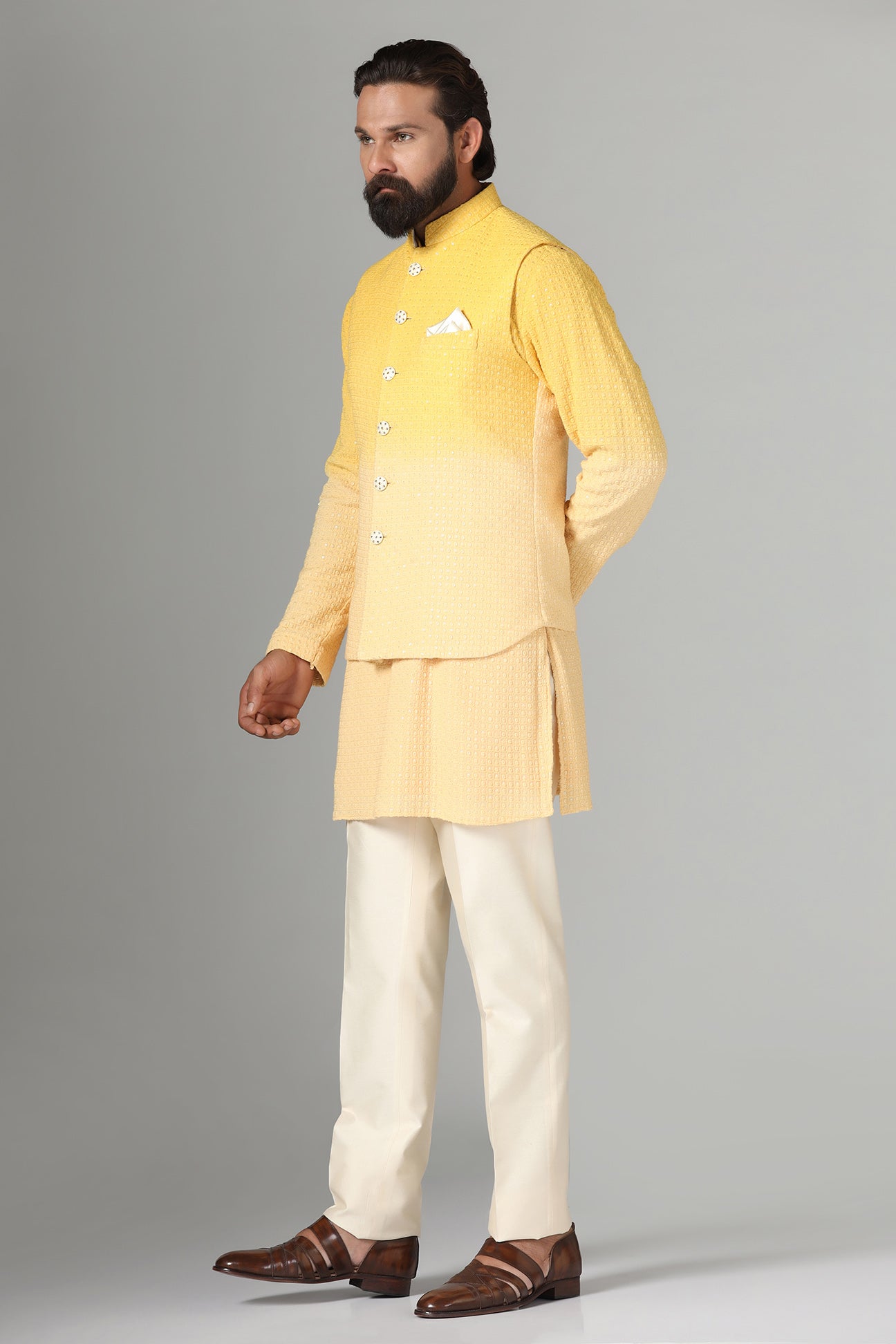 Radiate charm in our yellow ombre Nehru jacket, paired with ombre kurta and pajama. Shop Now!