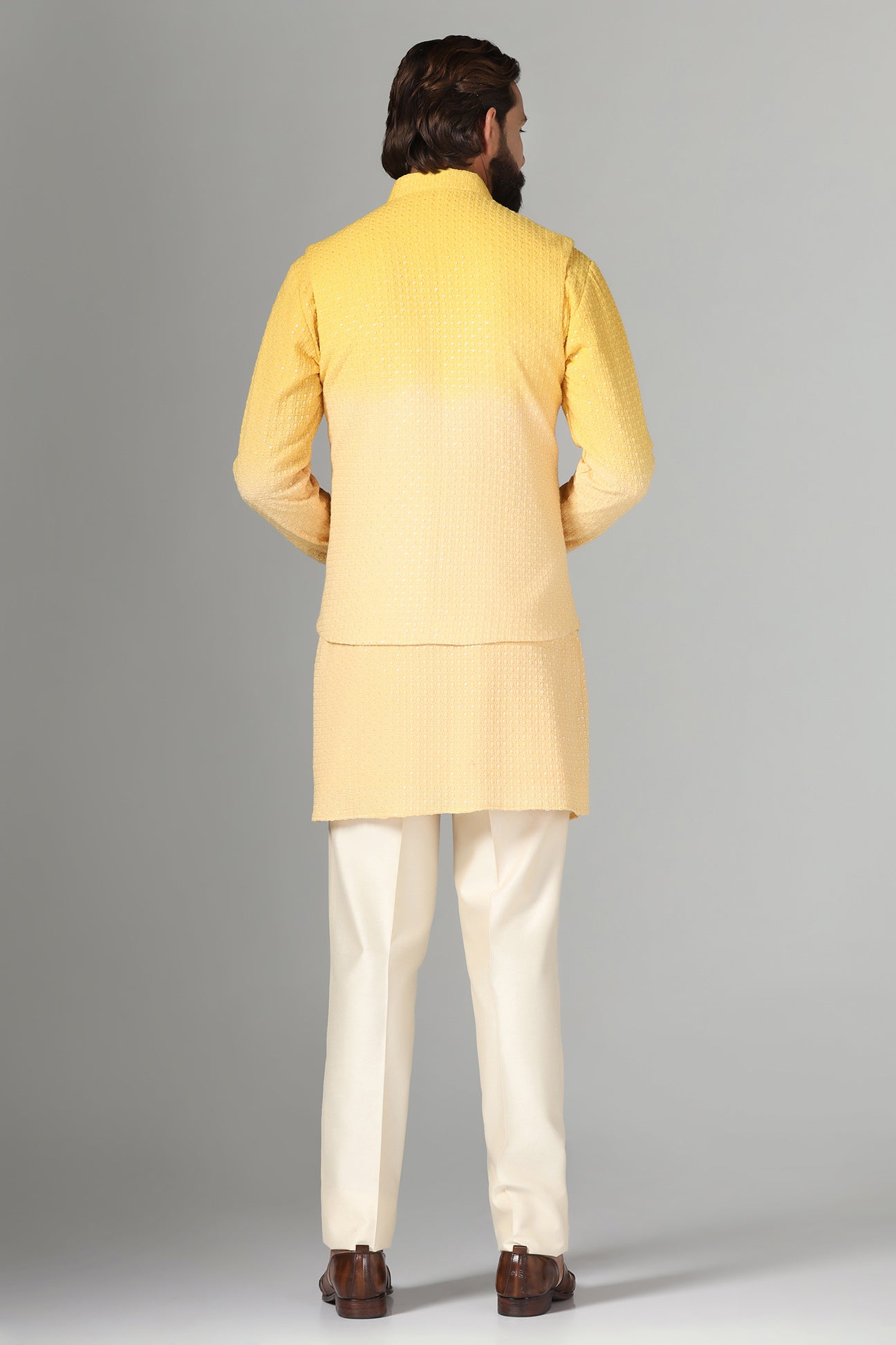 Radiate charm in our yellow ombre Nehru jacket, paired with ombre kurta and pajama. Shop Now!