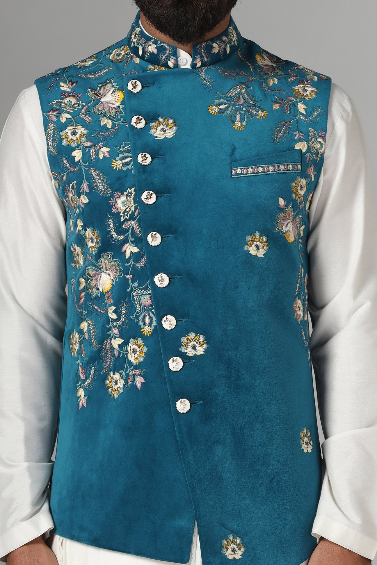 Step into elegance with our velvet Nehru jacket, boasting asymmetric floral embroidery. Shop Now!