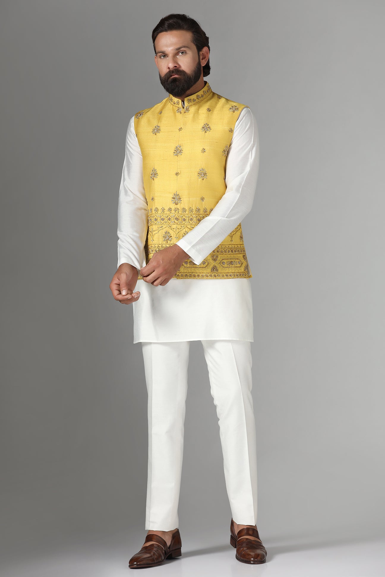 Radiate charm in our yellow raw-silk Nehru jacket with geometric and floral embroidery. Shop Now!