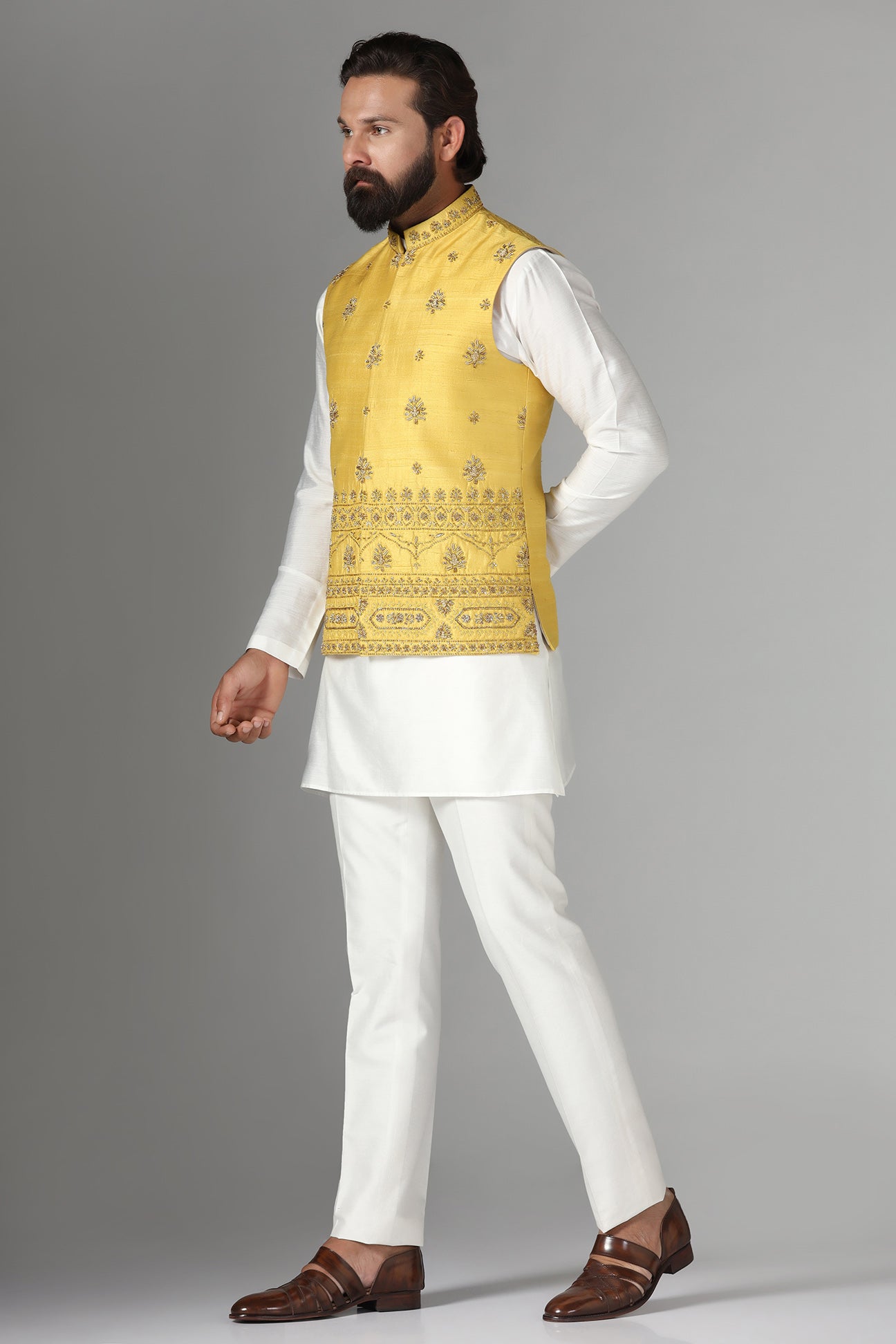 Radiate charm in our yellow raw-silk Nehru jacket with geometric and floral embroidery. Shop Now!