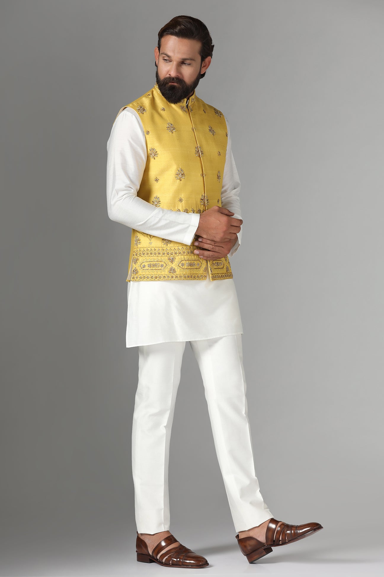 Radiate charm in our yellow raw-silk Nehru jacket with geometric and floral embroidery. Shop Now!