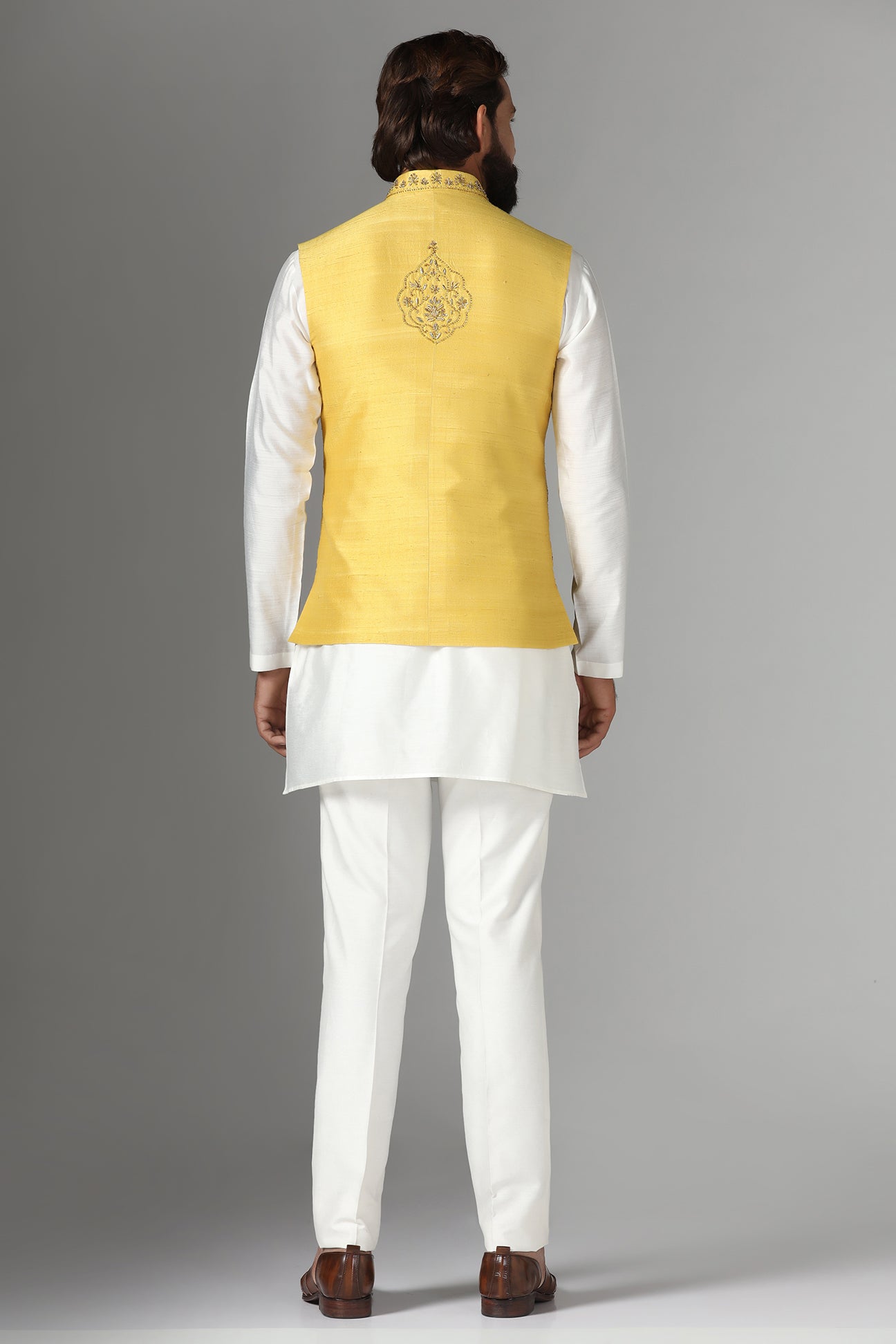 Radiate charm in our yellow raw-silk Nehru jacket with geometric and floral embroidery. Shop Now!