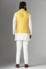 Radiate charm in our yellow raw-silk Nehru jacket with geometric and floral embroidery. Paired flawlessly with a coordinated off-white kurta pajama set.