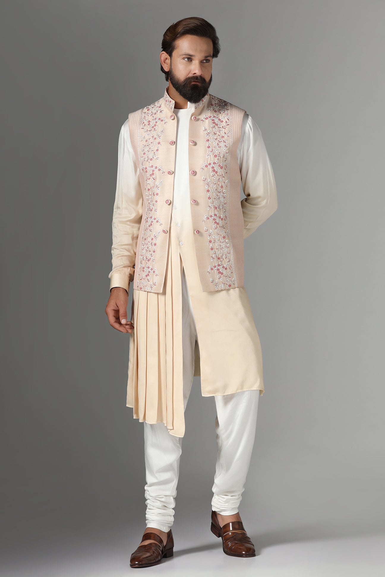 Elevate style with our light peach raw silk Nehru Jacket adorned with floral embroidery. Shop Now!