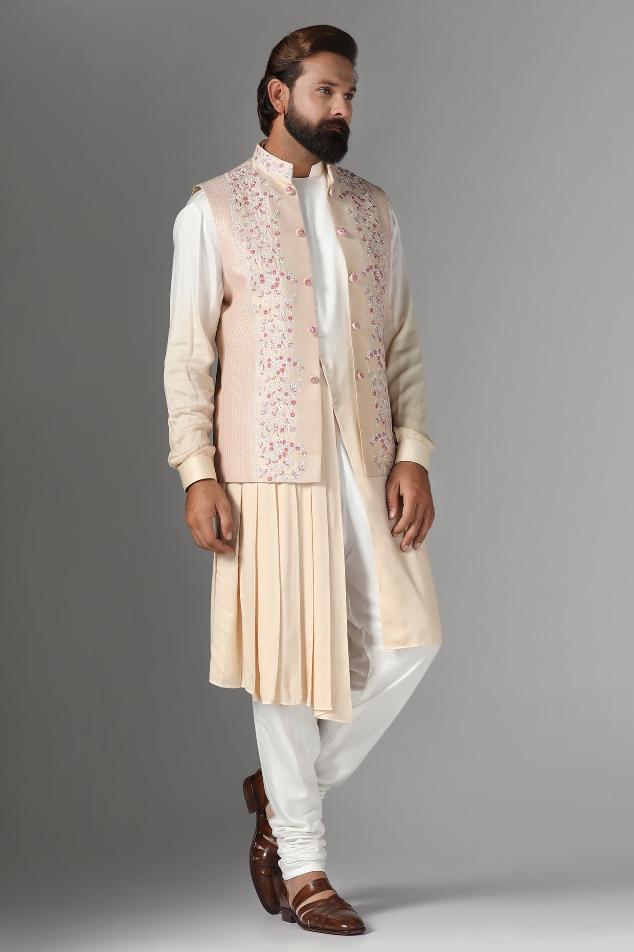 Elevate style with our light peach raw silk Nehru Jacket adorned with floral embroidery. Shop Now!