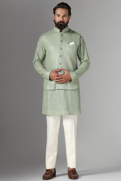 Radiate elegance in our light green Nehru Jacket adorned with sequin embroidery. Paired with an embroidered kurta and off-white trousers for refined sophistication.