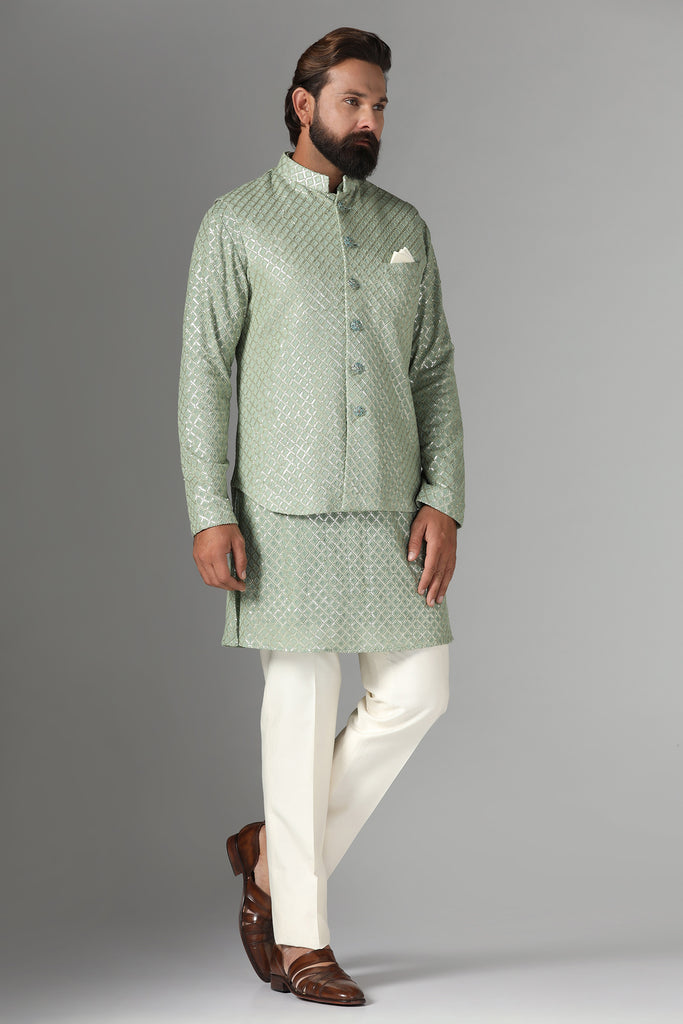 Radiate elegance in our light green Nehru Jacket adorned with sequin embroidery. Paired with an embroidered kurta and off-white trousers for refined sophistication.