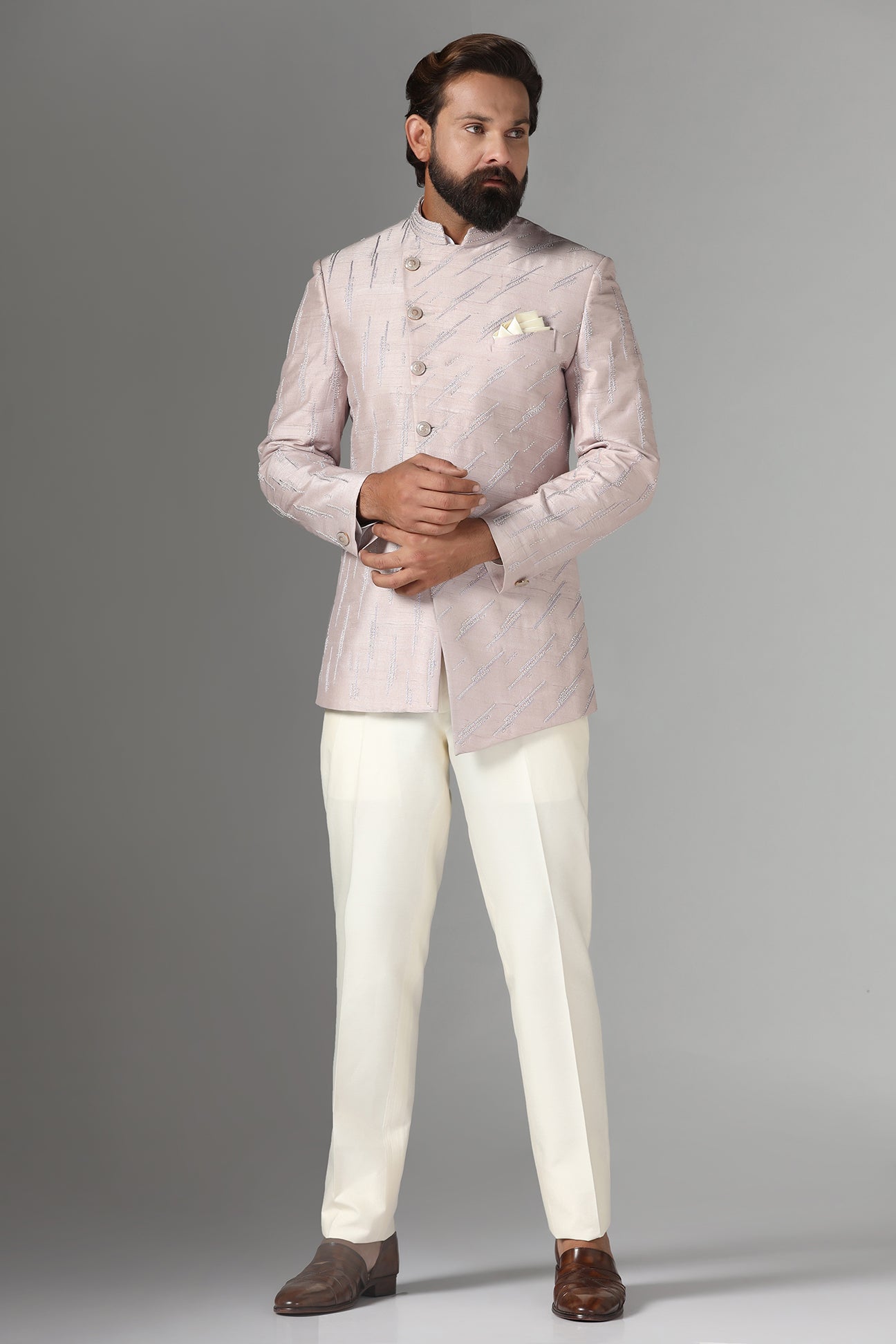 Shop the elegant pink Bandhgala suit with an asymmetric design. Shop now!