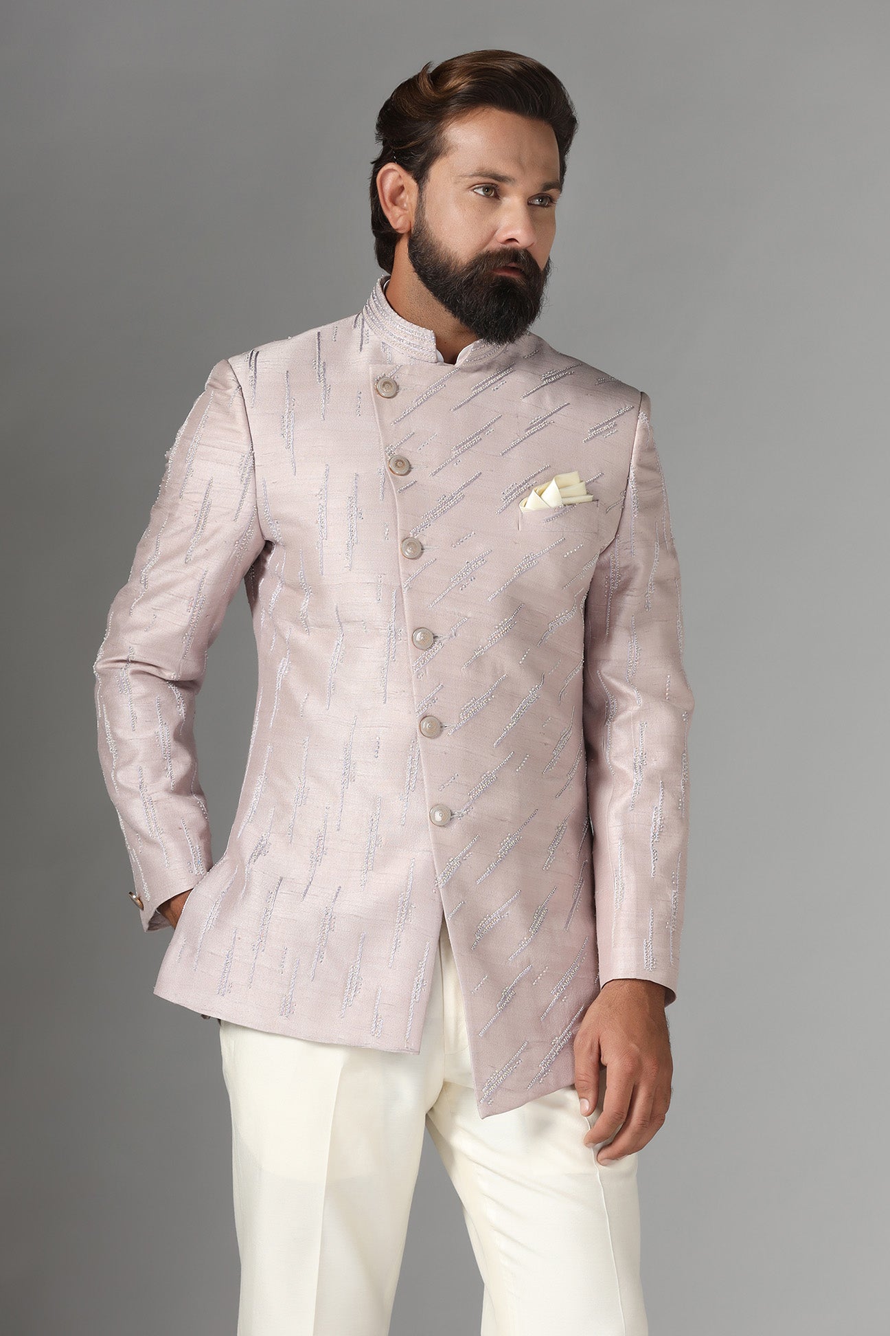 Shop the elegant pink Bandhgala suit with an asymmetric design. Shop now!