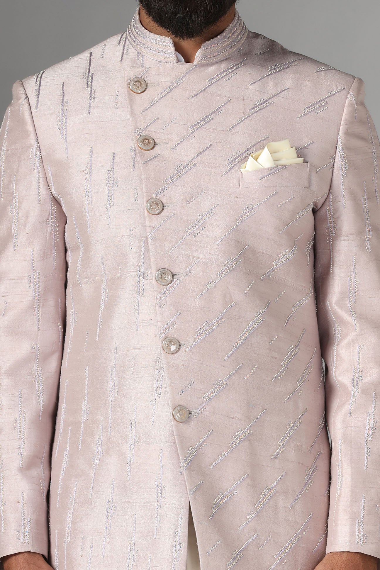 Shop the elegant pink Bandhgala suit with an asymmetric design. Shop now!