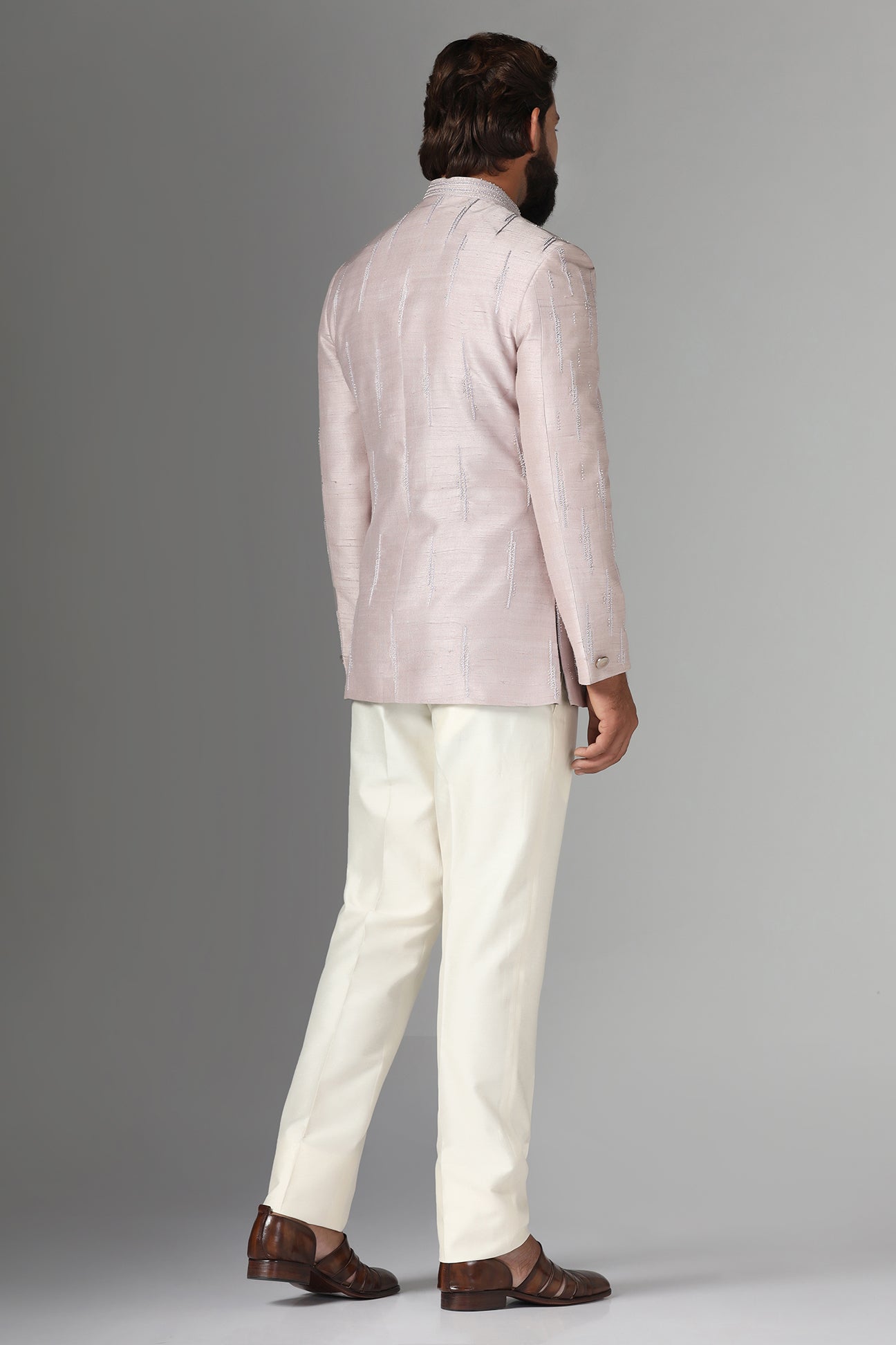 Shop the elegant pink Bandhgala suit with an asymmetric design. Shop now!