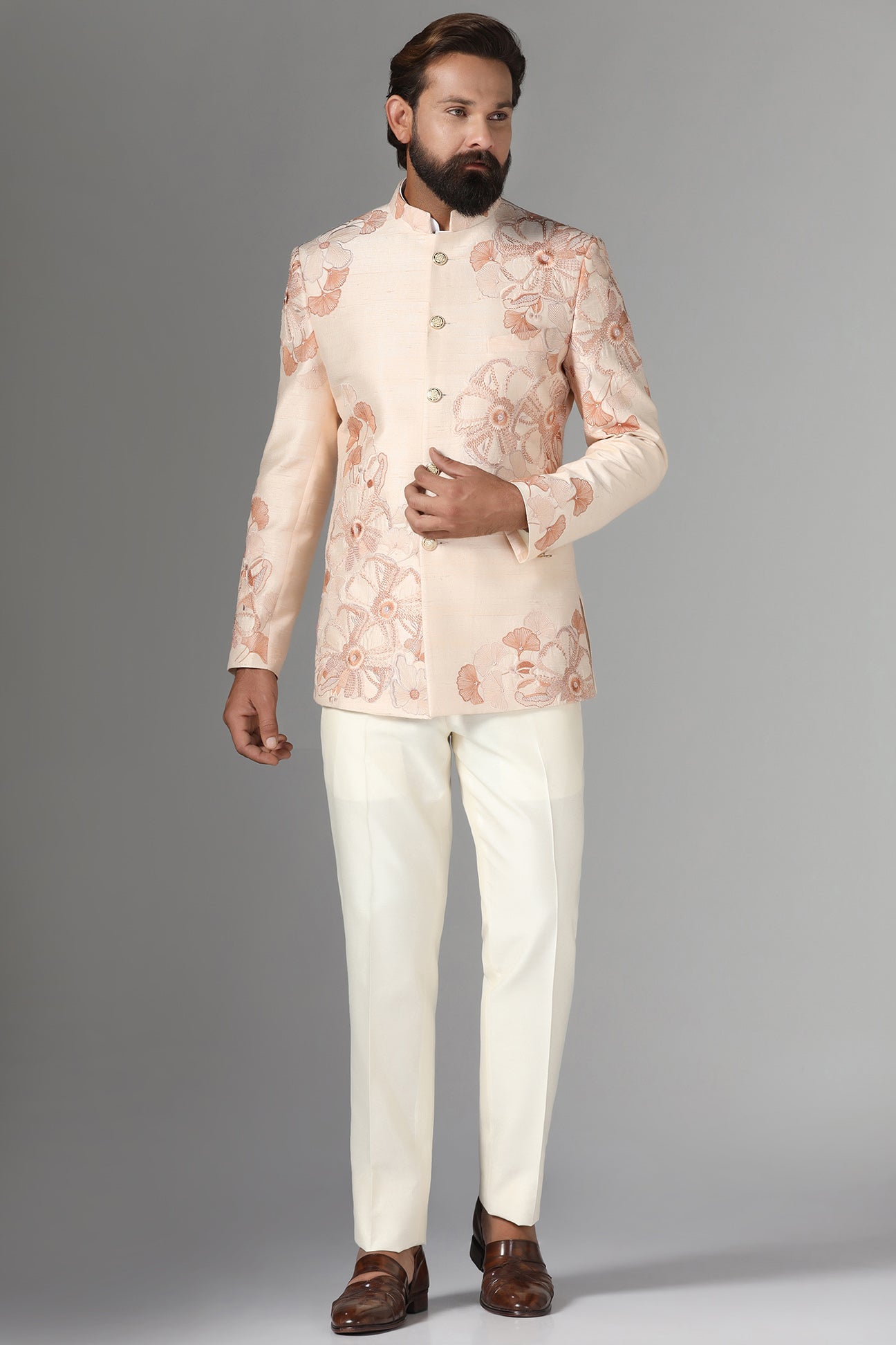 Dress in sophistication with our light peach Bandhgala suit in raw-silk fabric. Shop Now!