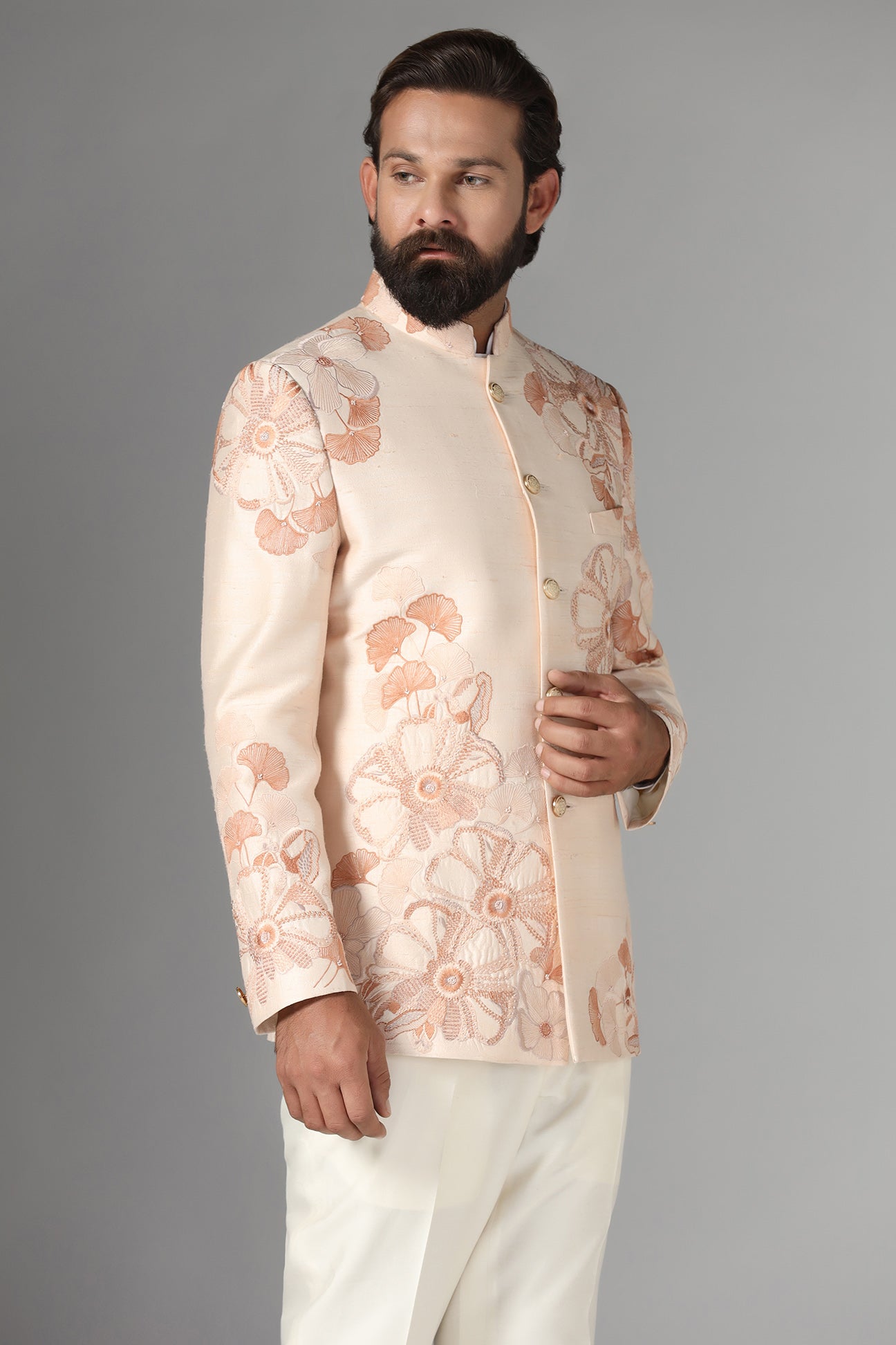 Dress in sophistication with our light peach Bandhgala suit in raw-silk fabric. Shop Now!