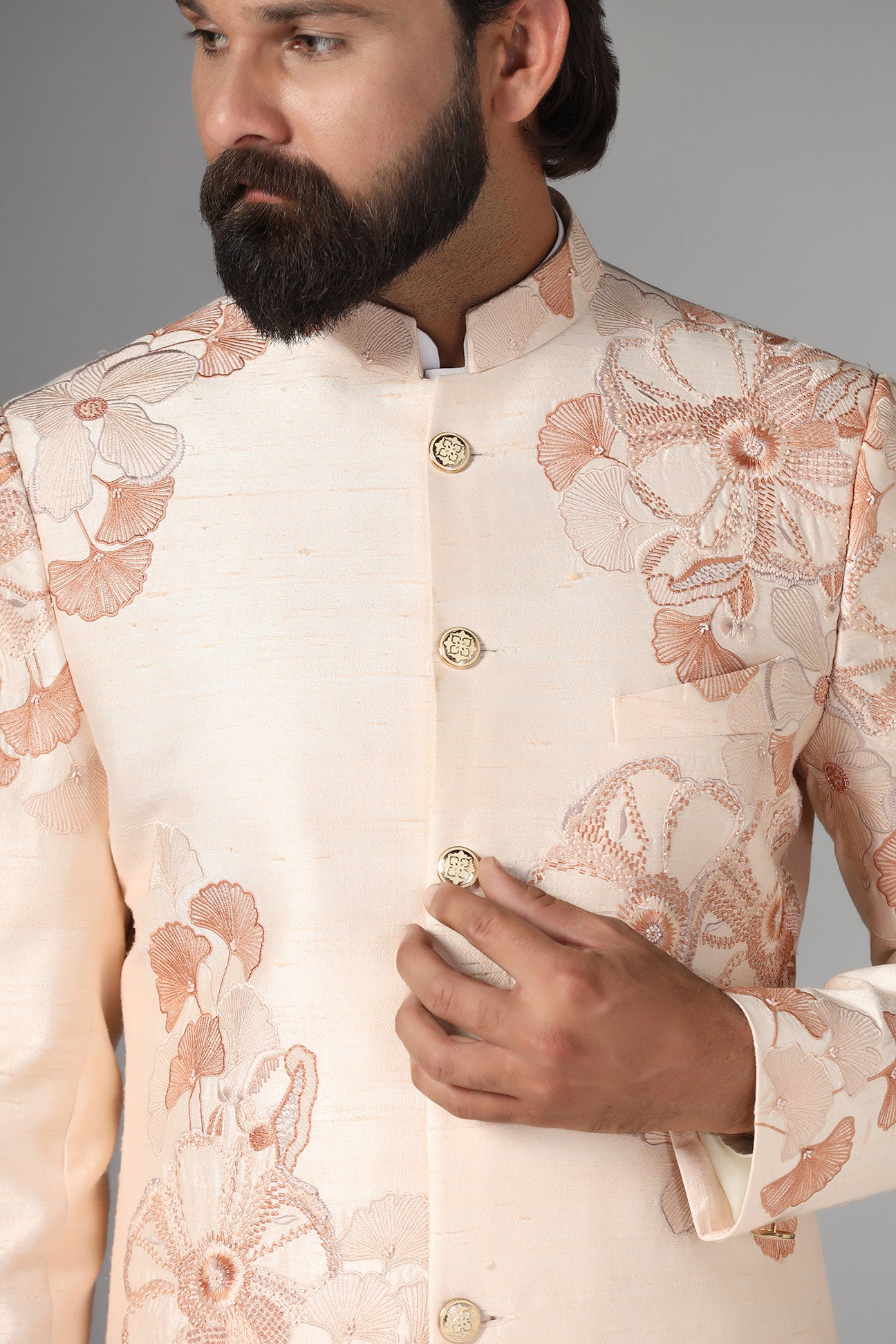 Dress in sophistication with our light peach Bandhgala suit in raw-silk fabric. Shop Now!
