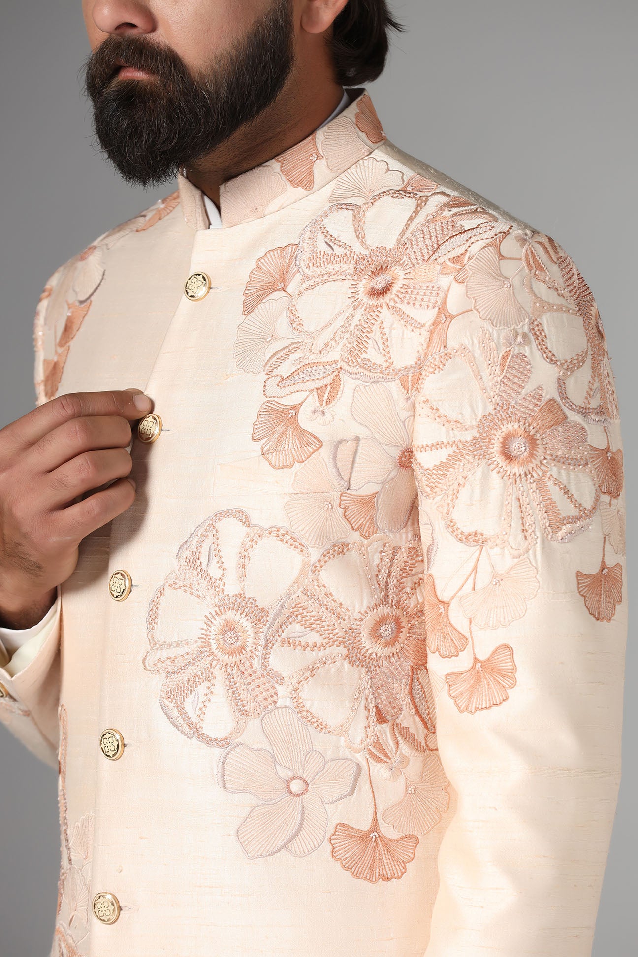 Dress in sophistication with our light peach Bandhgala suit in raw-silk fabric. Shop Now!