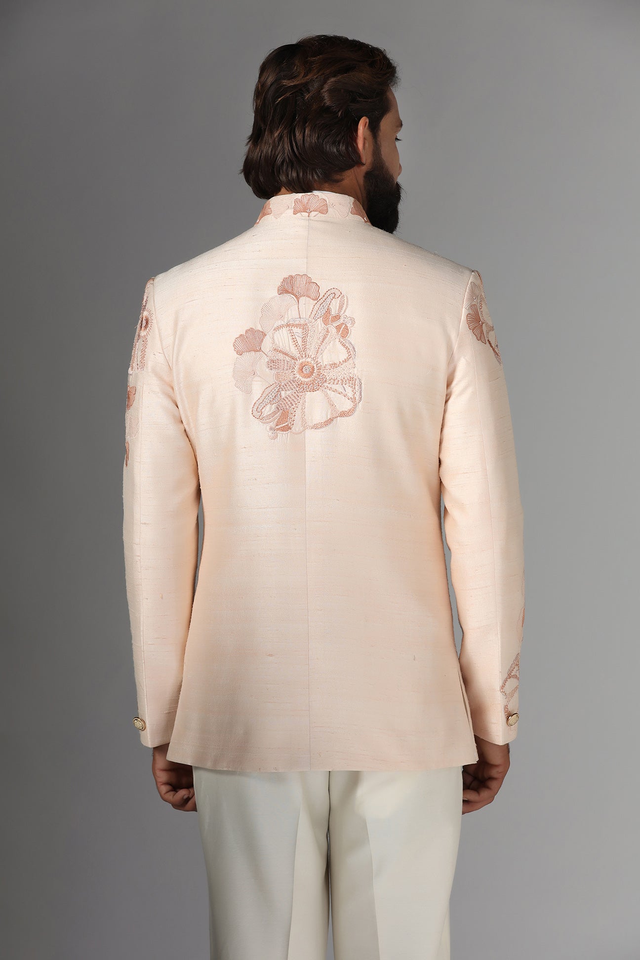 Dress in sophistication with our light peach Bandhgala suit in raw-silk fabric. Shop Now!