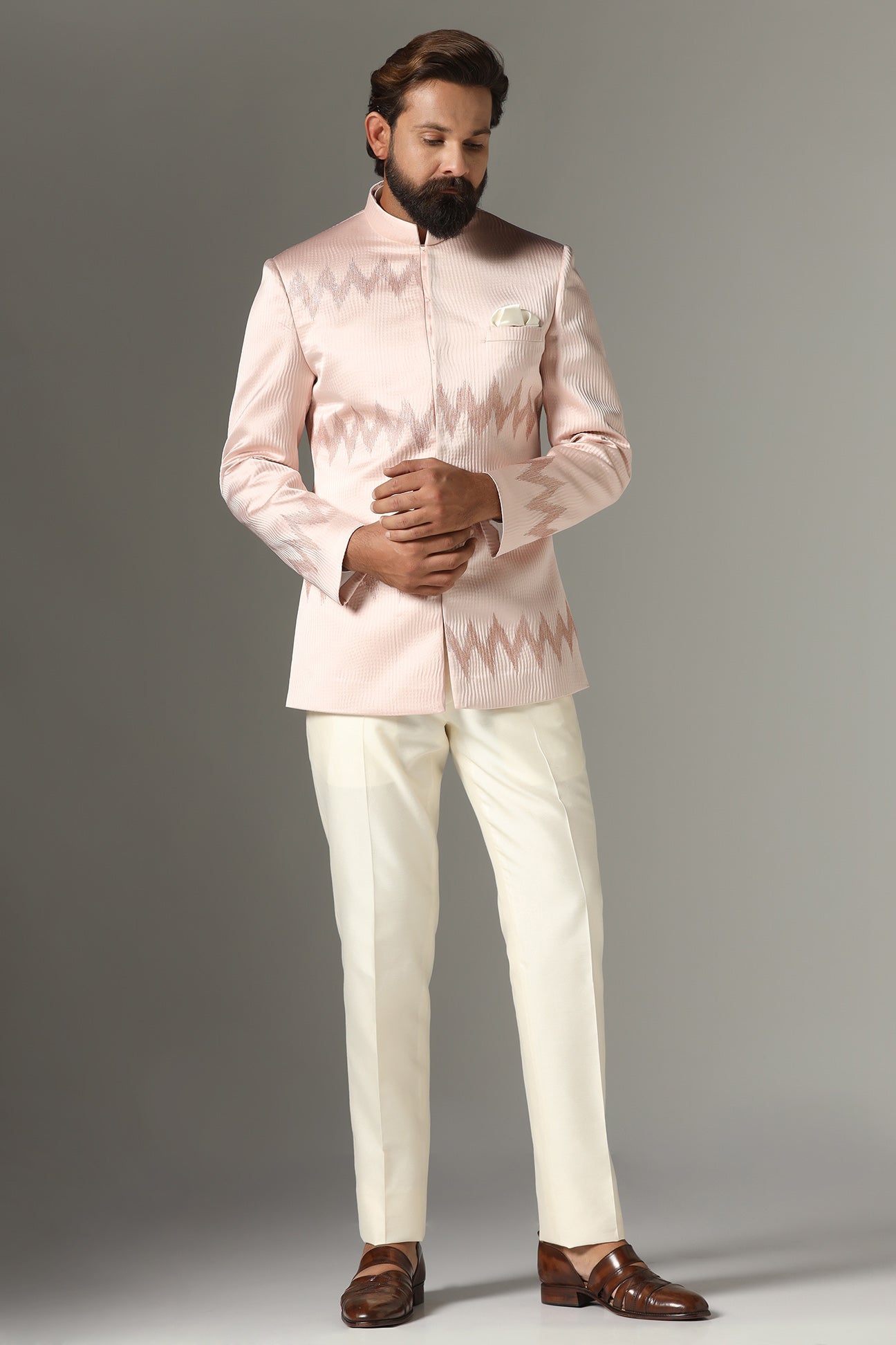 Radiate elegance in our light pink textured Bandhgala suit. Shop Now!