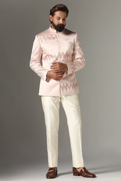 Radiate elegance in our light pink textured Bandhgala suit, paired with off-white trousers for a timeless ensemble.