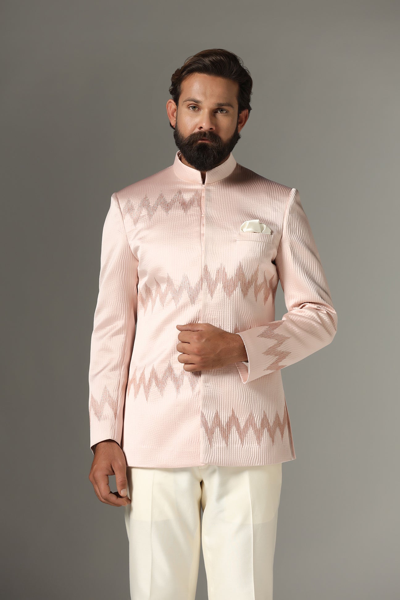 Radiate elegance in our light pink textured Bandhgala suit. Shop Now!
