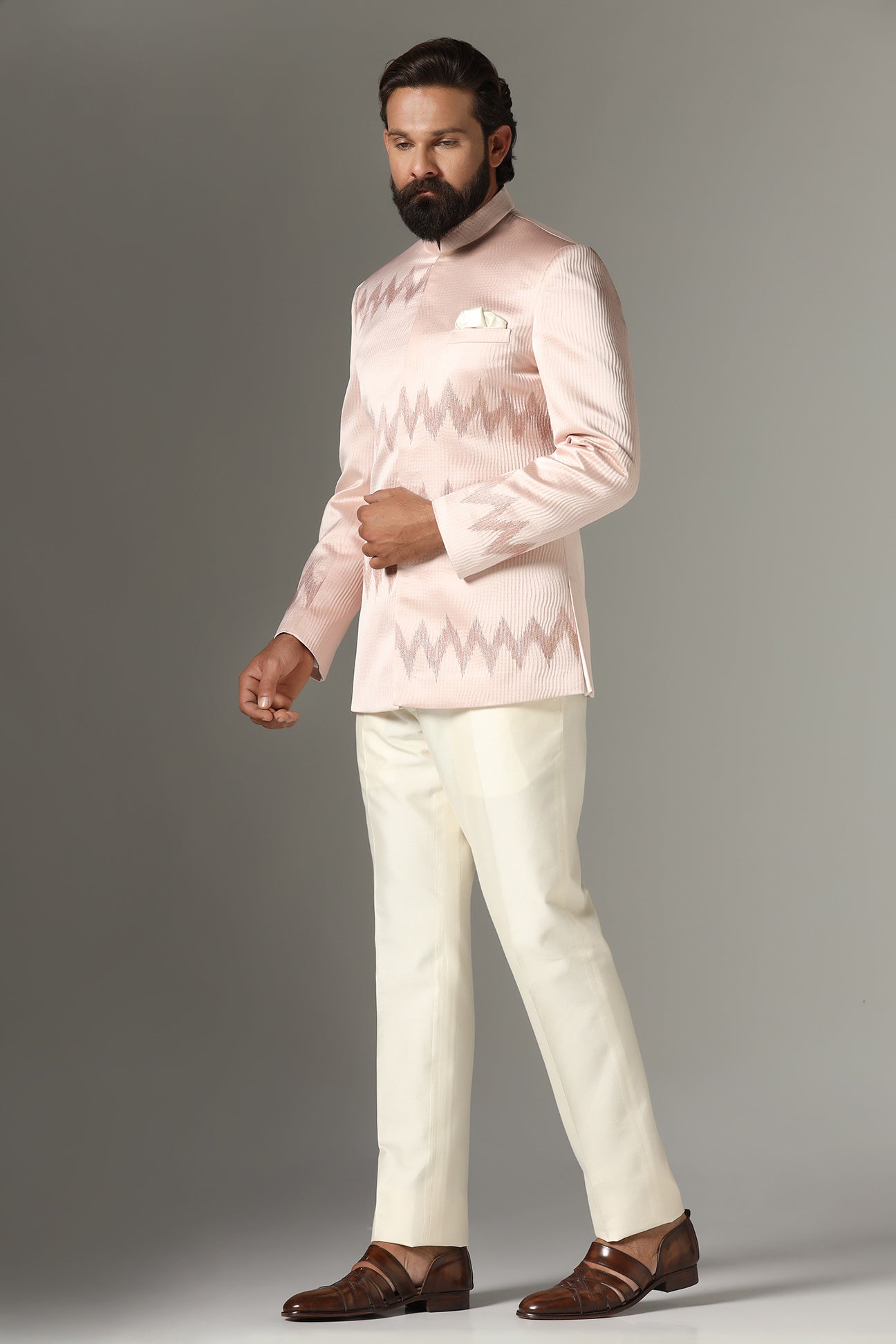 Radiate elegance in our light pink textured Bandhgala suit. Shop Now!