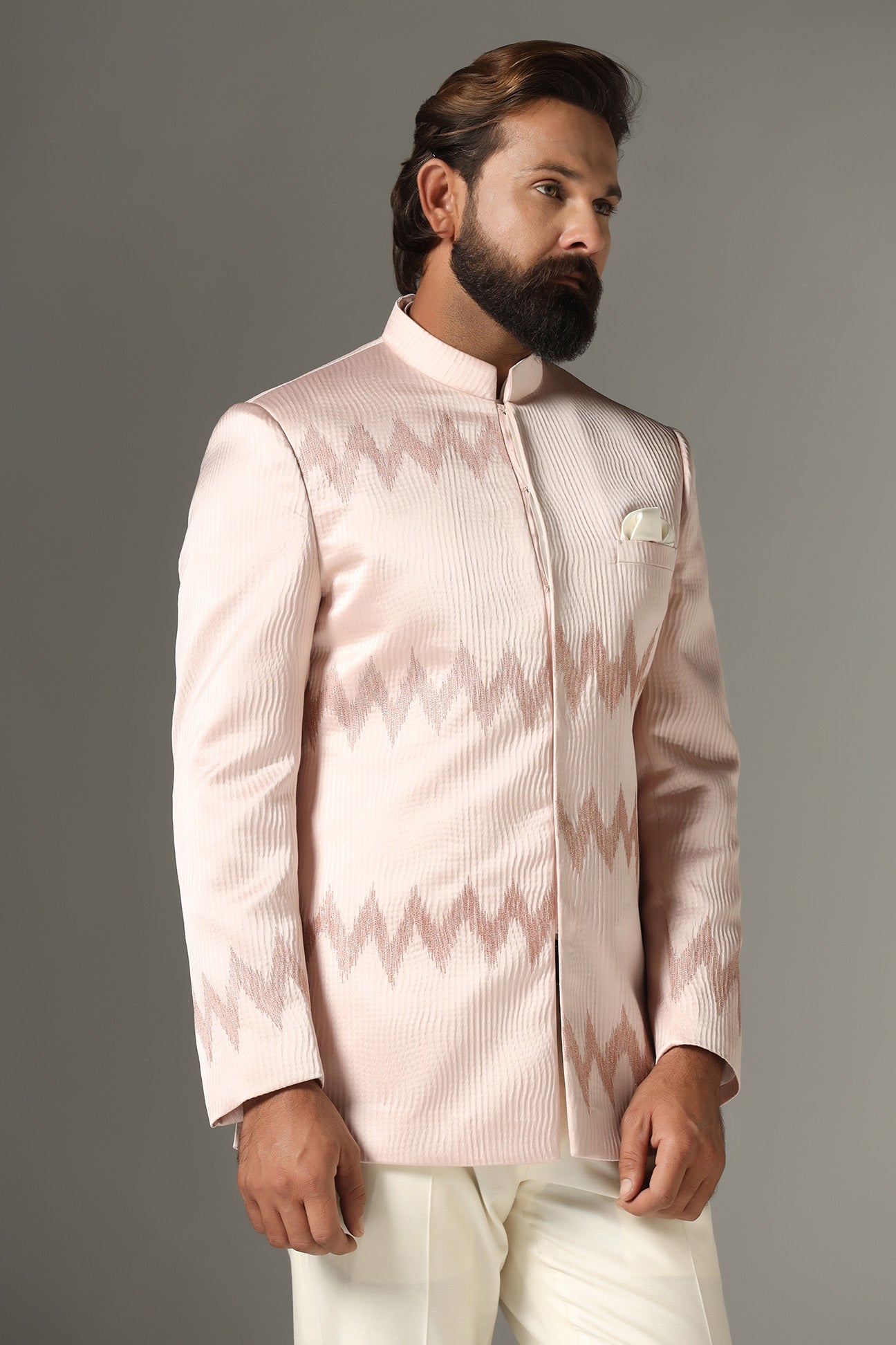 Radiate elegance in our light pink textured Bandhgala suit. Shop Now!