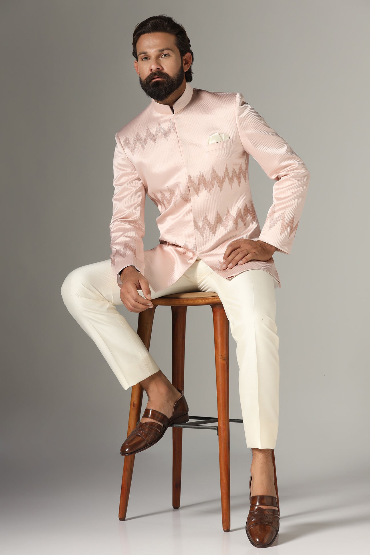 Radiate elegance in our light pink textured Bandhgala suit. Shop Now!