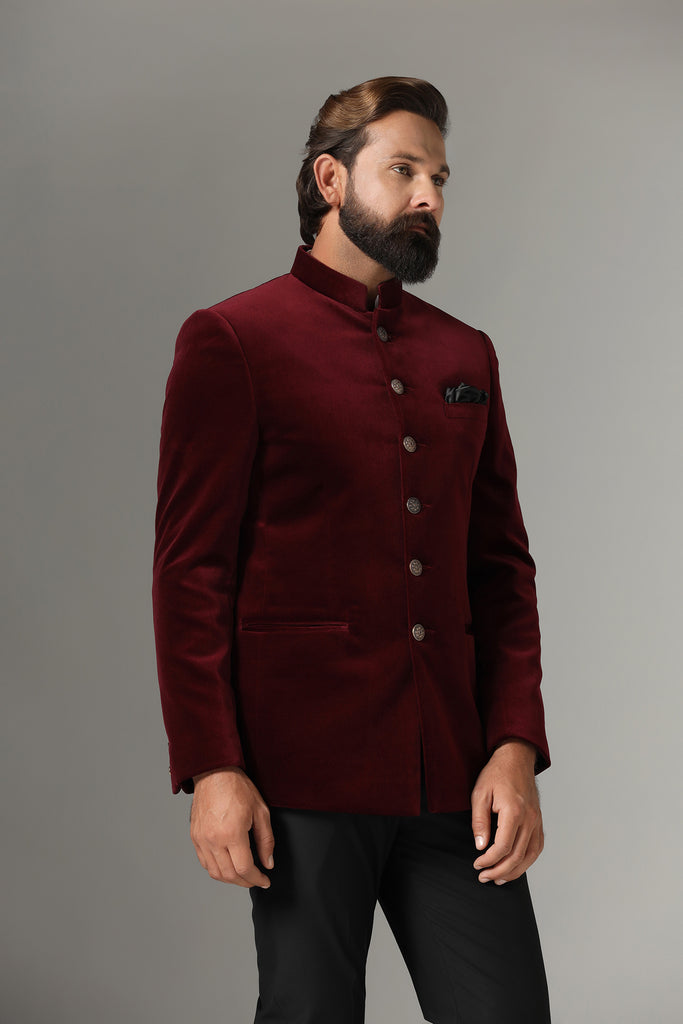 Dress in regal elegance with our velvet maroon Bandhgala featuring a contrast six-button closure. Paired with plain black trousers. Accessories sold separately.