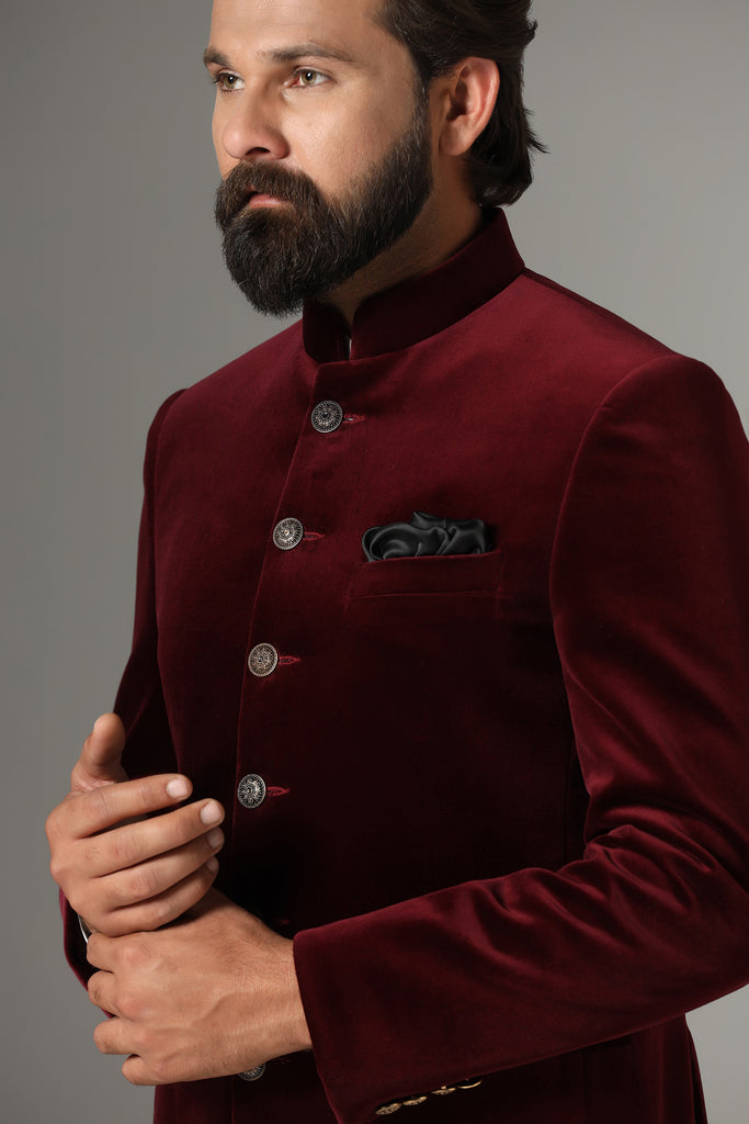 Dress in regal elegance with our velvet maroon Bandhgala featuring a contrast six-button closure. Paired with plain black trousers. Accessories sold separately.