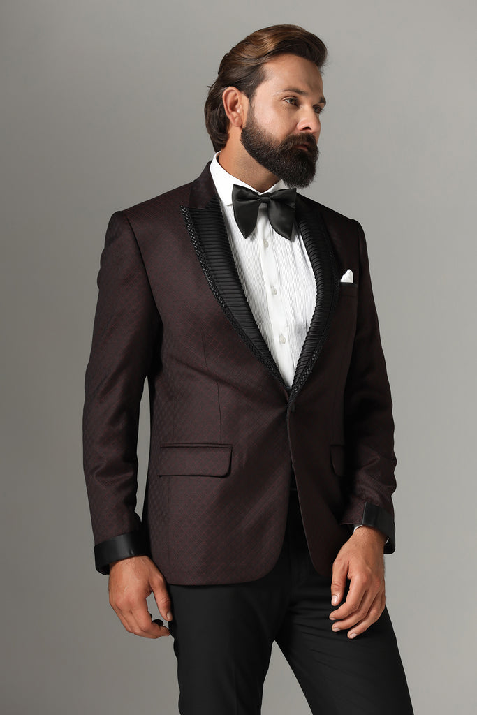 Elevate your style with our Wine-Textured Tuxedo. Peak collar adorned with subtle embroidery and pintucks. Crafted from wool-rich fabric, paired with Jet-Black trousers.