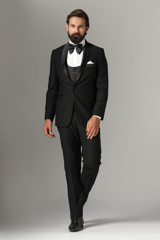 Elevate your formal look with our 3-Piece Black Tuxedo. Wool-rich fabric, shawl collar in black satin. Complete with jet-black waistcoat and trousers.