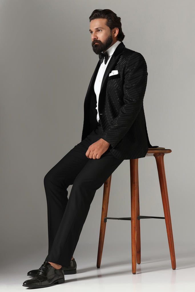 Exude sophistication in our Black Wool-Rich Embroidered Tuxedo. Featuring a black velvet peak lapel and jet-black trousers for timeless elegance.