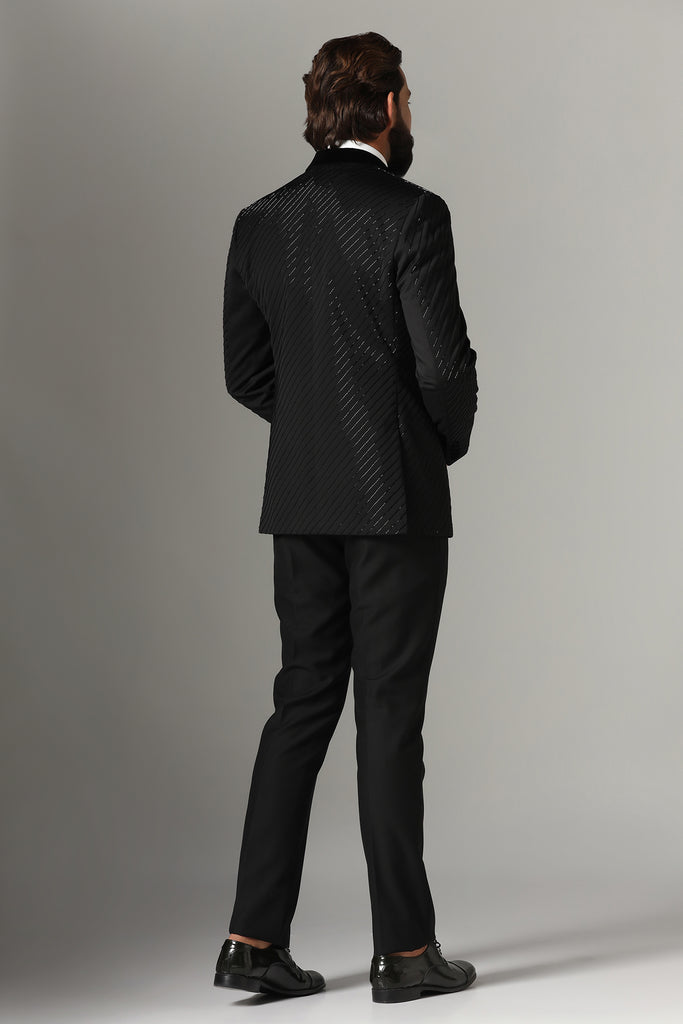 Exude sophistication in our Black Wool-Rich Embroidered Tuxedo. Featuring a black velvet peak lapel and jet-black trousers for timeless elegance.