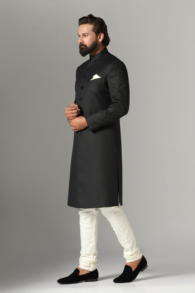 Elevate your style with our black Indowestern ensemble, crafted from luxurious wool-rich fabric. Includes kurta and churidar set. Accessories sold separately for personalized flair.