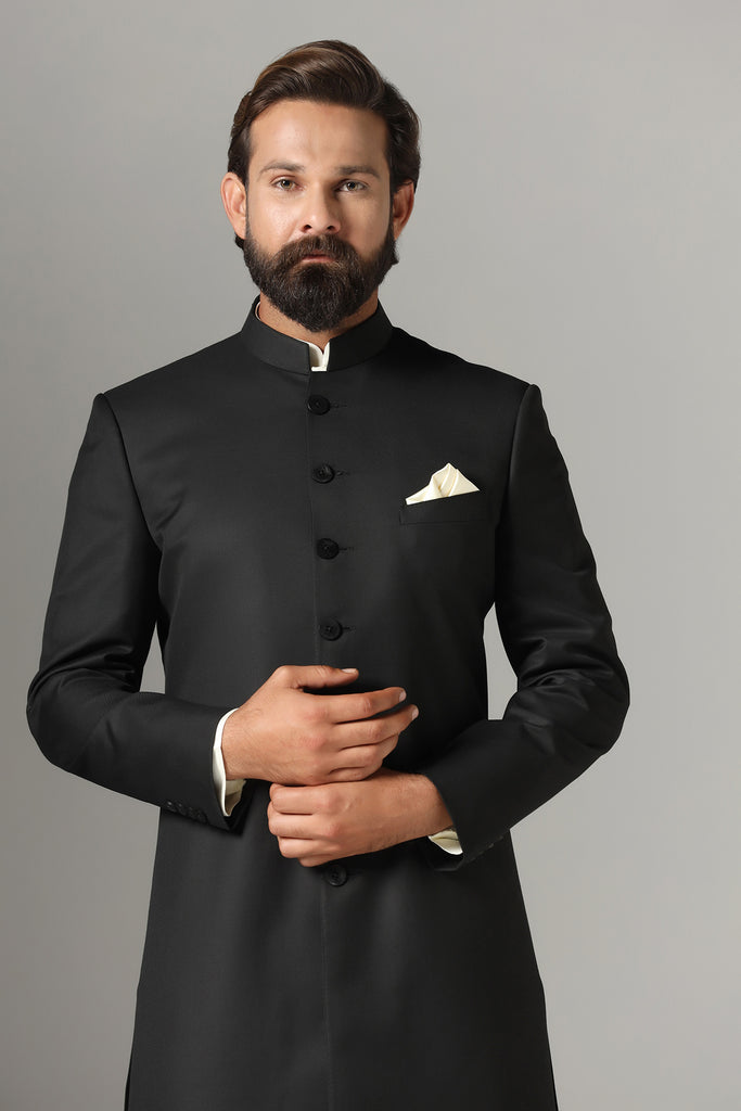 Elevate your style with our black Indowestern ensemble, crafted from luxurious wool-rich fabric. Includes kurta and churidar set. Accessories sold separately for personalized flair.