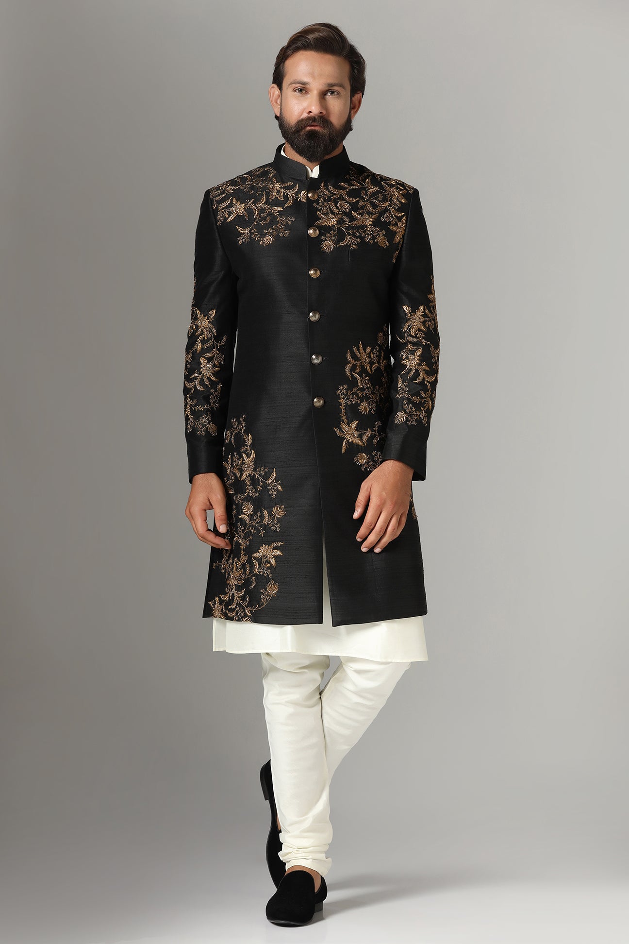 This black raw-silk Indowestern is highlighted with golden embroidery. Shop Now!