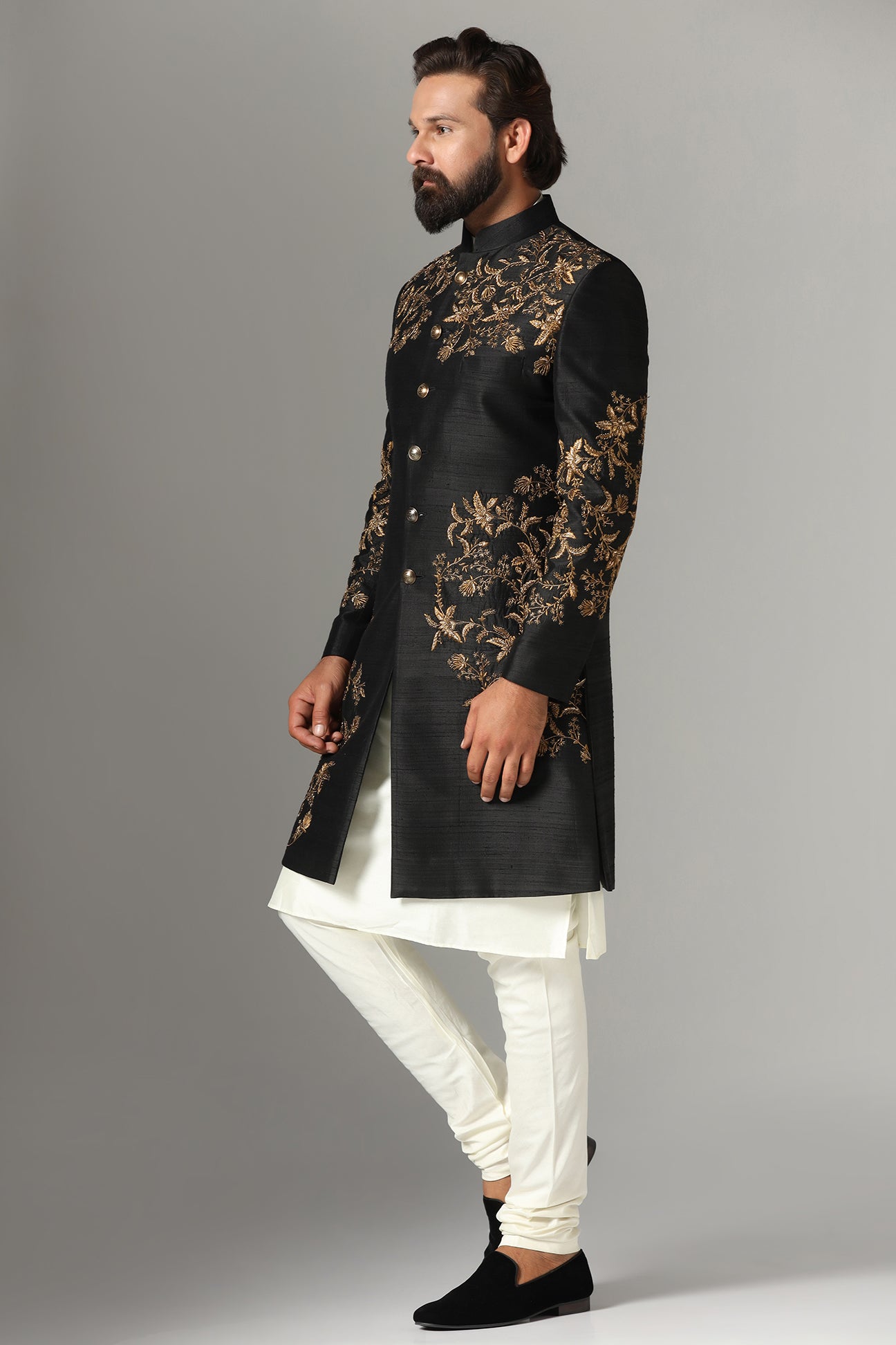 This black raw-silk Indowestern is highlighted with golden embroidery. Shop Now!