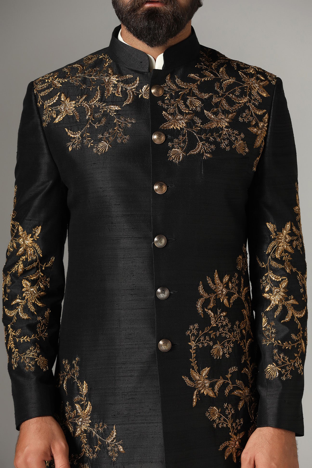 This black raw-silk Indowestern is highlighted with golden embroidery. Shop Now!