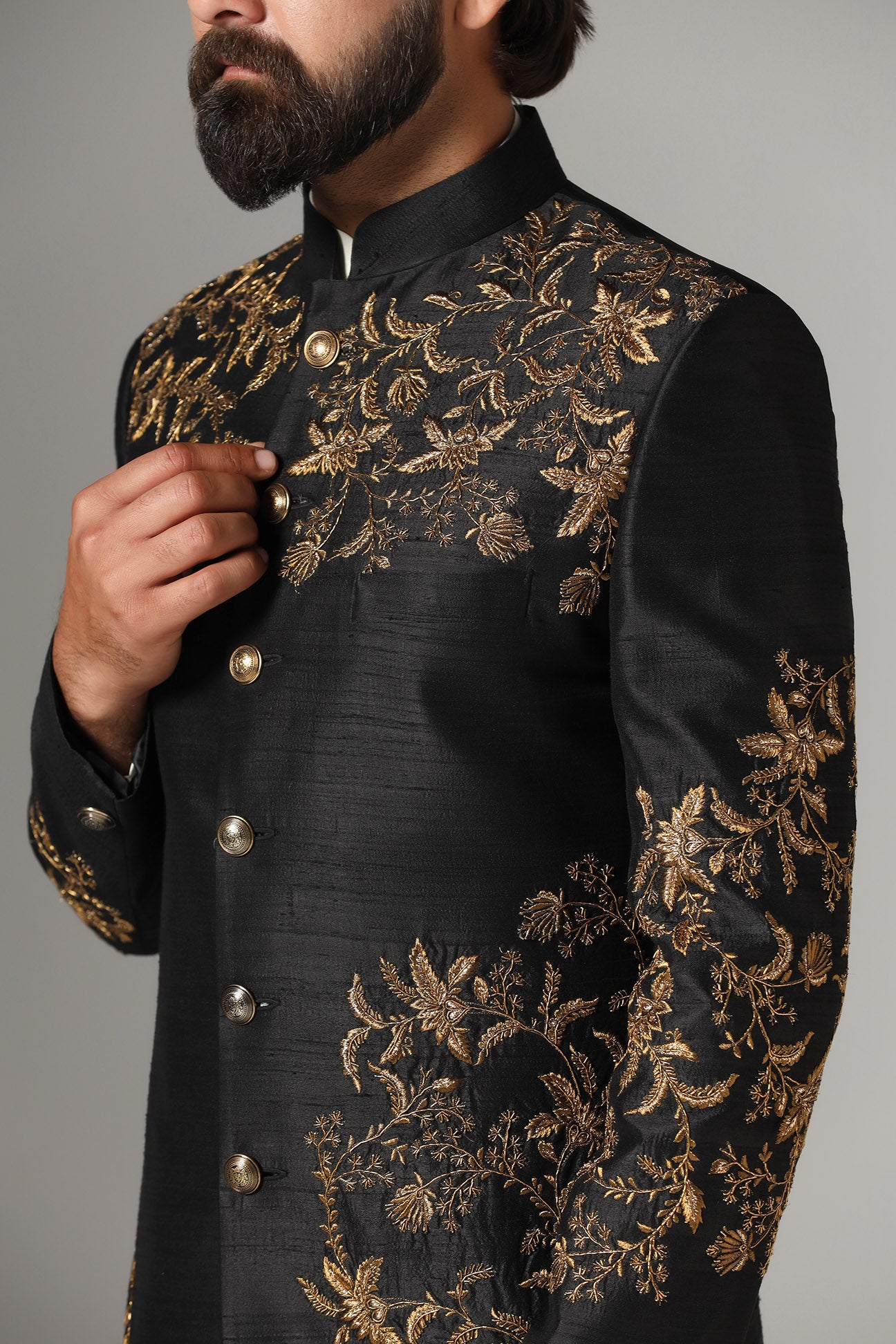This black raw-silk Indowestern is highlighted with golden embroidery. Shop Now!